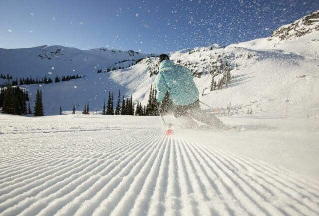 Downhill skiing in Whistler in spring on groomed slopes