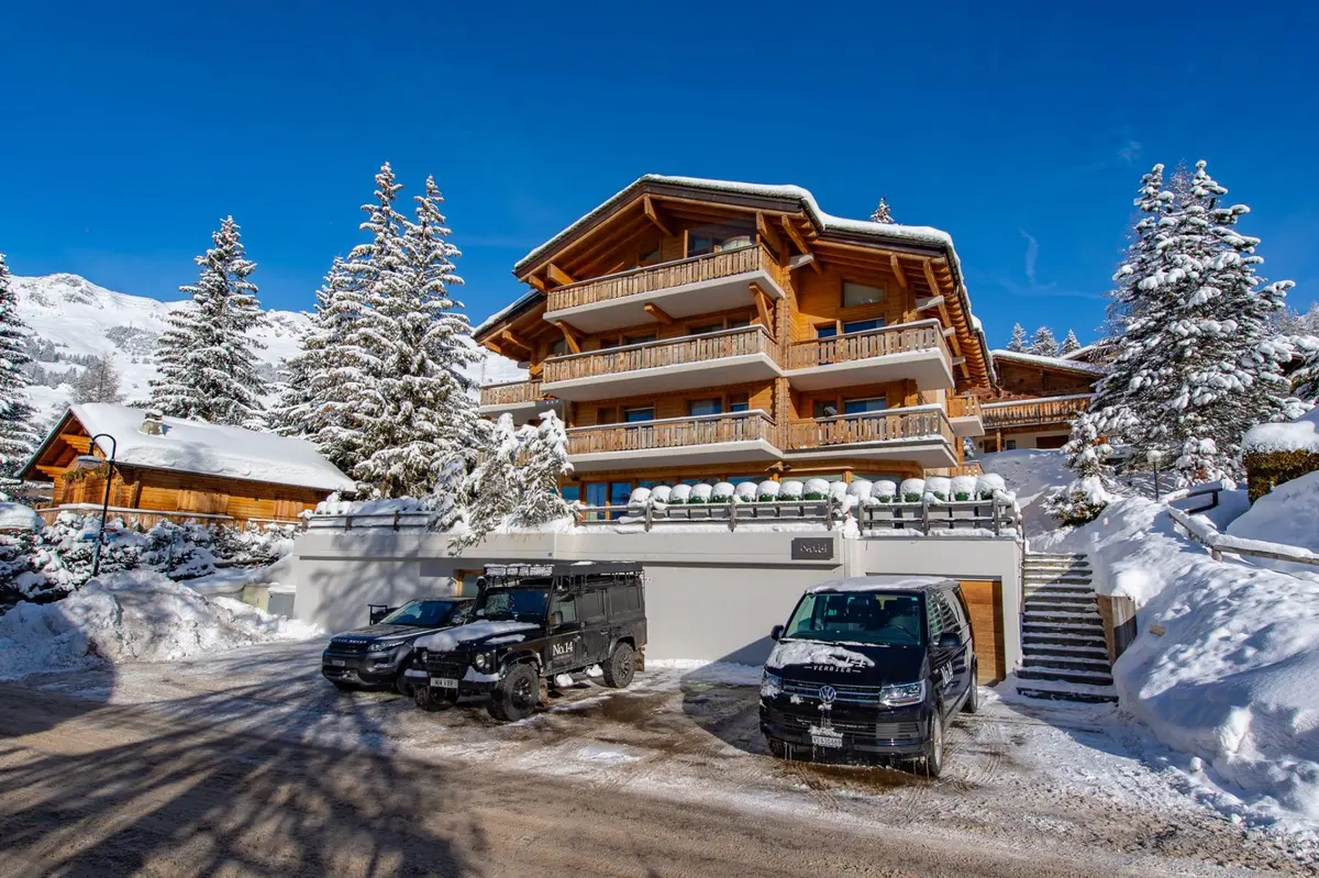 large wooden chalet covered in snow